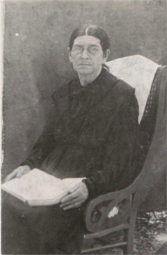 Alethia 'Letha' DICKERSON HOLDER portrait in rocking chair with backdrop and glasses on