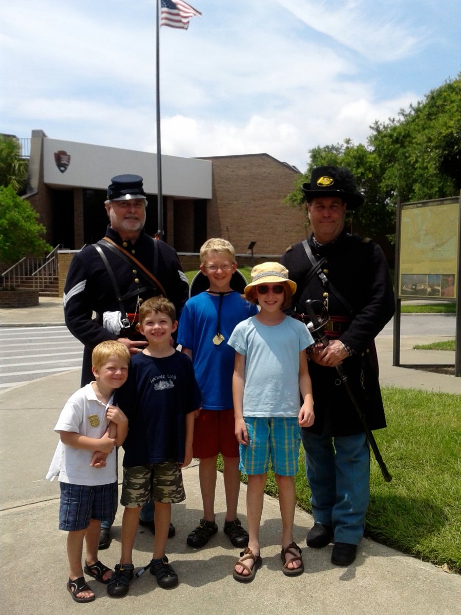 Two Civil War Reenactment Soldiers Pose with Children